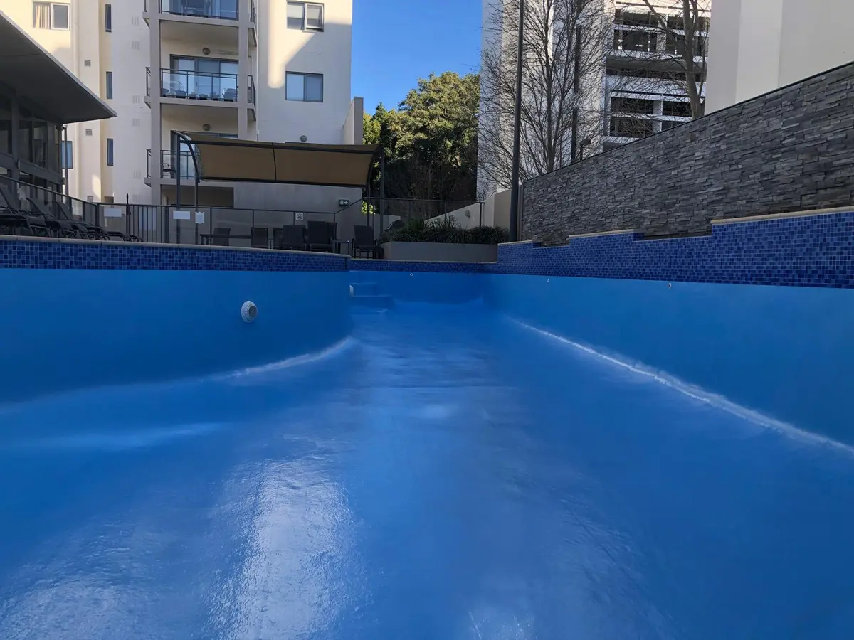 Completed blue fibreglass pool finish below mosaic waterline tiles